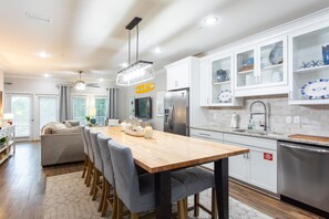 Enjoy cooking in this well-equipped kitchen with a central island, stainless steel appliances, and ample storage.