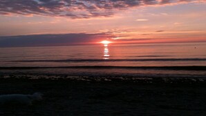 A sunset over a calm sea with a beach in the foreground. - "Fasti" - 300m from the sea by Interhome (Gilleleje)