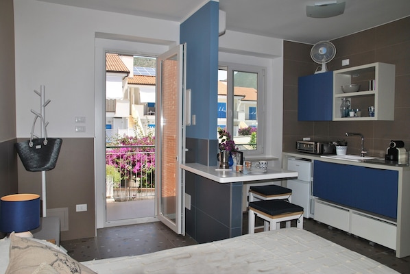 A modern kitchen with a built-in oven, a microwave, and a coffee machine.