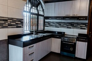 Superior Apartment, 5 Bedrooms | Private kitchen | Fridge, microwave, oven, stovetop - Nyumbani Cottages - Kicukiro (Kigali)