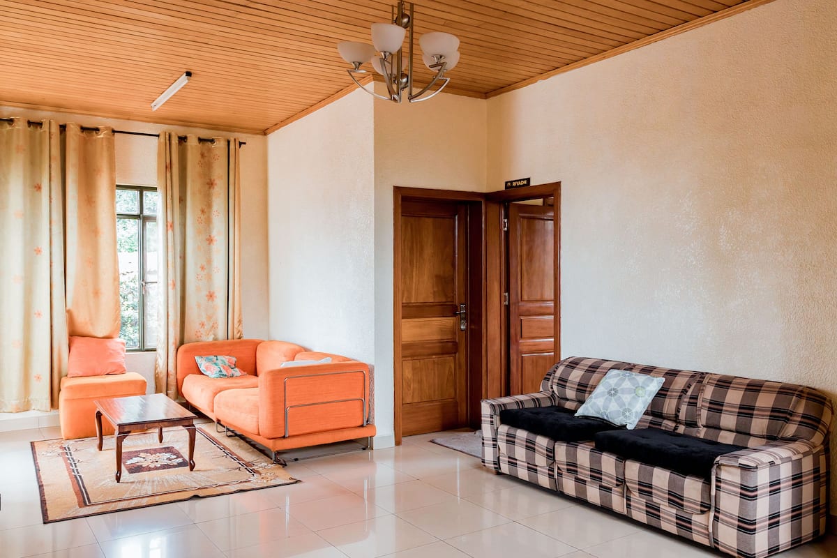 A living room with two sofas, a coffee table, and a wooden door.