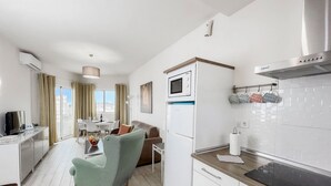 A modern kitchen with a built-in oven, microwave, and stainless steel range hood. - Club Maritimo Front line Beach Apartments (Fuengirola)