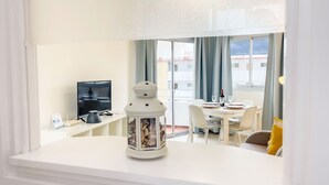 A room with a dining area, a TV, and a decorative lantern.