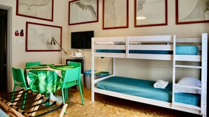 A bunk bed room with a desk, chairs, and framed maps on the wall. - Guest House Sonnino 37 Cagliari (Cagliari)