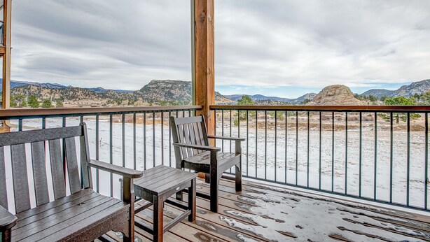 A wooden deck with a bench and table, overlooking a desert landscape with mountains. - Mountain Lake View - Hot tub/Fireplace! (Estes Park)