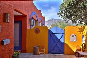 A building with a red facade, blue door, and a blue gate. - Casa De Monte Vista Pet Friendly (Tucson)