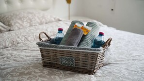 A wicker basket with a 'Home' sign on a bed with patterned bedding. - Cozy Sea View Apt w/ pool access + Netflix (Larnaka)