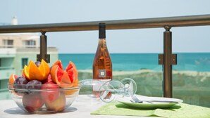 A table with a fruit bowl, a wine bottle, and a glass on a balcony overlooking the sea. - PRESTIGE CITY2  (Primorsko)