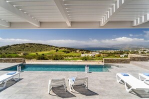 A pool area with two lounge chairs and a view of the landscape.