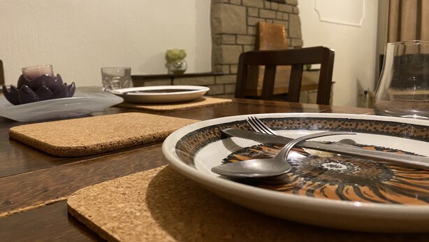 A dining table with a plate, cutlery, and a candle holder. - Serene 3/4BR in Harborne (Harborne)