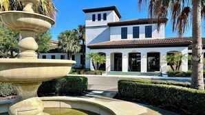 A fountain in a landscaped area with a building in the background. - Pool Privacy! Value! Resort 6 mi 2 Disney! 1712 (Kissimmee)