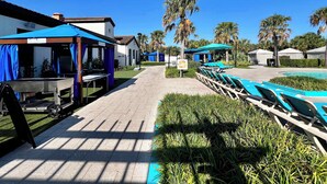 A resort with a pool area, lounge chairs, and covered seating areas. - Pool Privacy! Value! Resort 6 mi 2 Disney! 1712 (Kissimmee)