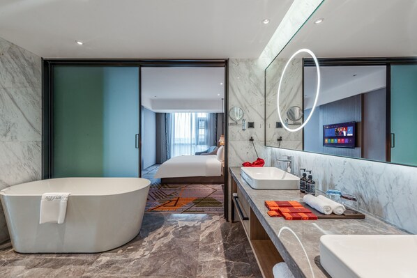 Un baño moderno con una ba ñera amplia, lavamanos doble y un espejo grande.
