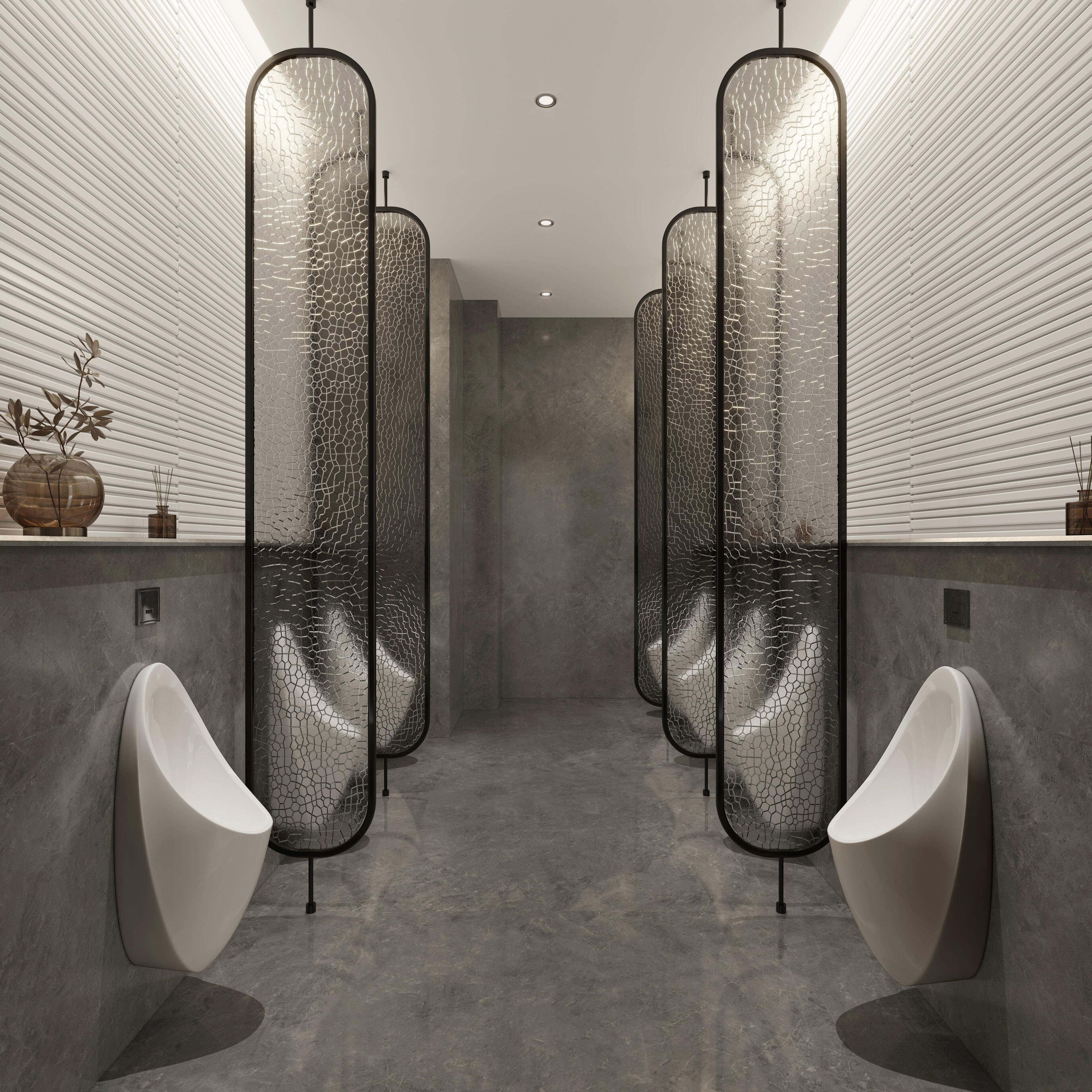 A modern bathroom with sleek, curved urinals and a minimalist design.