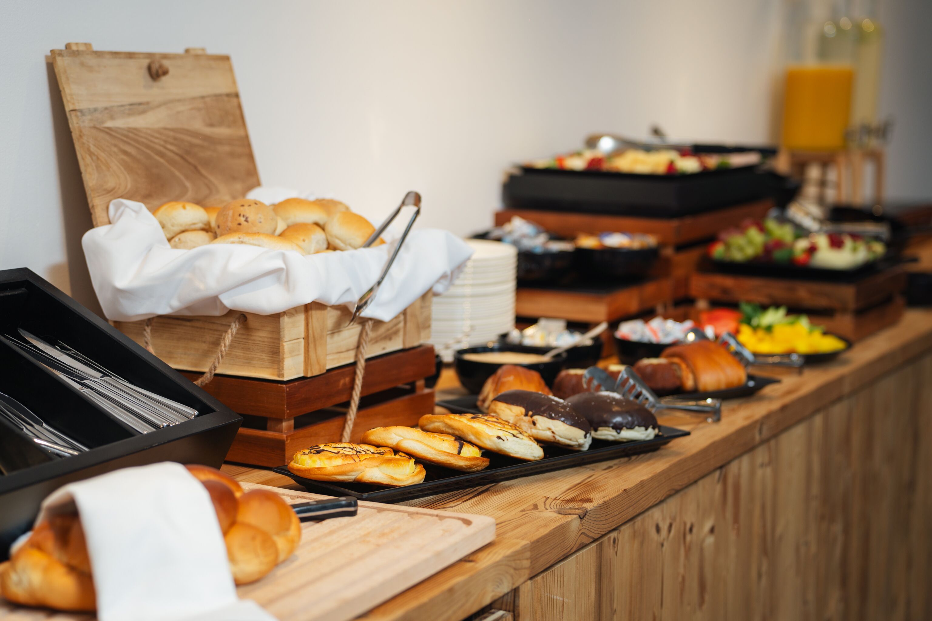 A buffet with various food items including pastries, fruits, and vegetables.