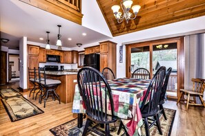 A spacious kitchen with wooden cabinets, a central island, and modern appliances. - Stepaway Vacation Rentals-LCR#3 (St. Germain)