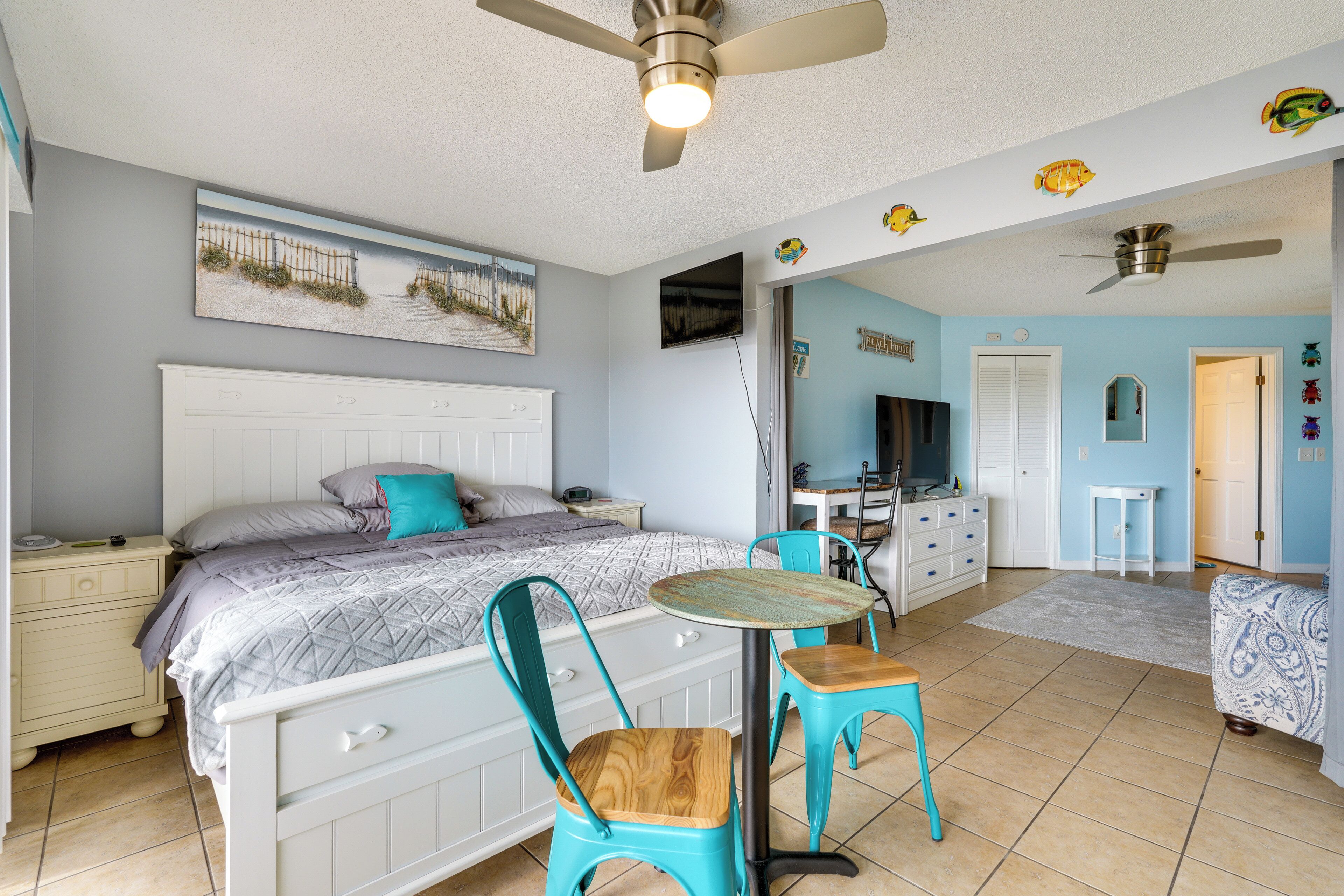 A bedroom with a bed, a desk, and a chair.