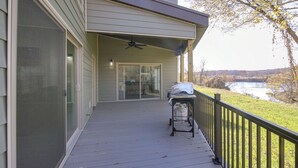 A covered porch with a grill and a view of a lake. - Pet-friendly Cotter Retreat w/ Deck & Gas Grill! (Cotter)