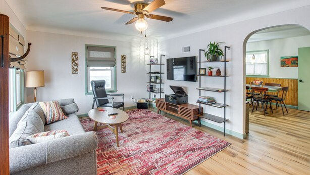 A living room with a sofa, coffee table, TV, and entertainment unit. - Pet-friendly Hiawatha Retreat w/ Private Yard! (Hiawatha)