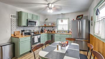 Prepare meals in the central island kitchen with a sink, microwave, and oven.