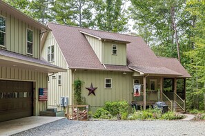 A two-story building with a porch and a star decoration. - Waterfront Lake Anna Home w/ Private Dock (Mineral)