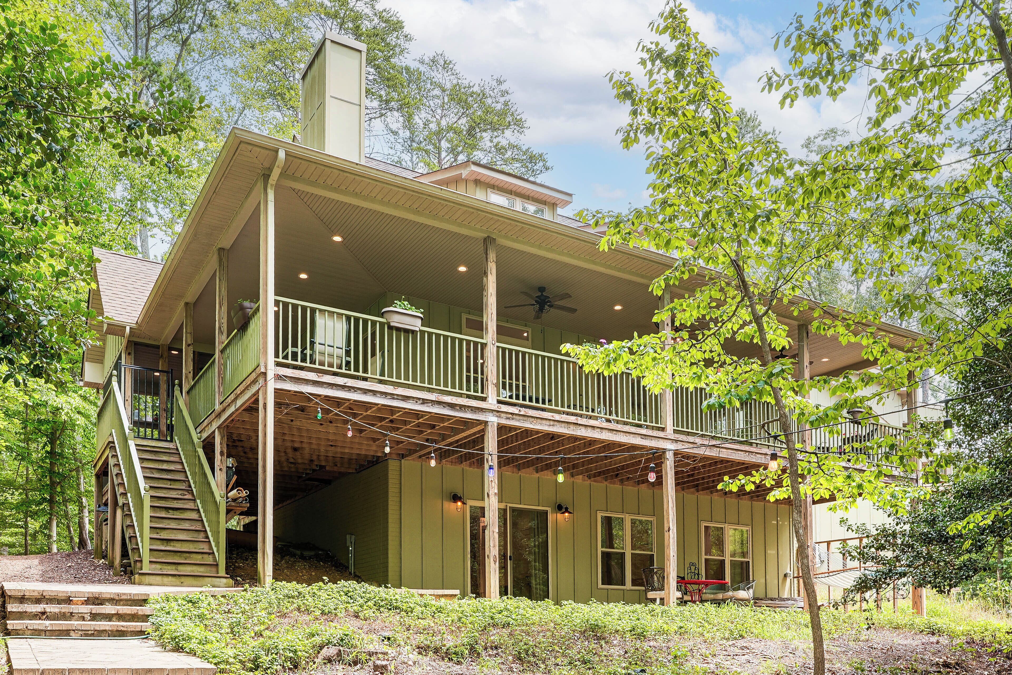 A two-story building with a balcony, a staircase, and a covered porch area.