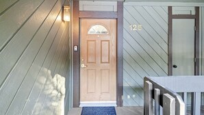 A wooden front door with a glass panel, a mailbox, and a number '126' on the wall. - Sunshine Village 126: Pet friendly, Close to Green (Mammoth Lakes)