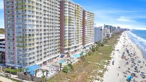 A high-rise hotel with multiple balconies, a pool area, and a beachside location. - Bay Watch 632 - Multiple Pools, Hot Tubs, & Lazy River (North Myrtle Beach)