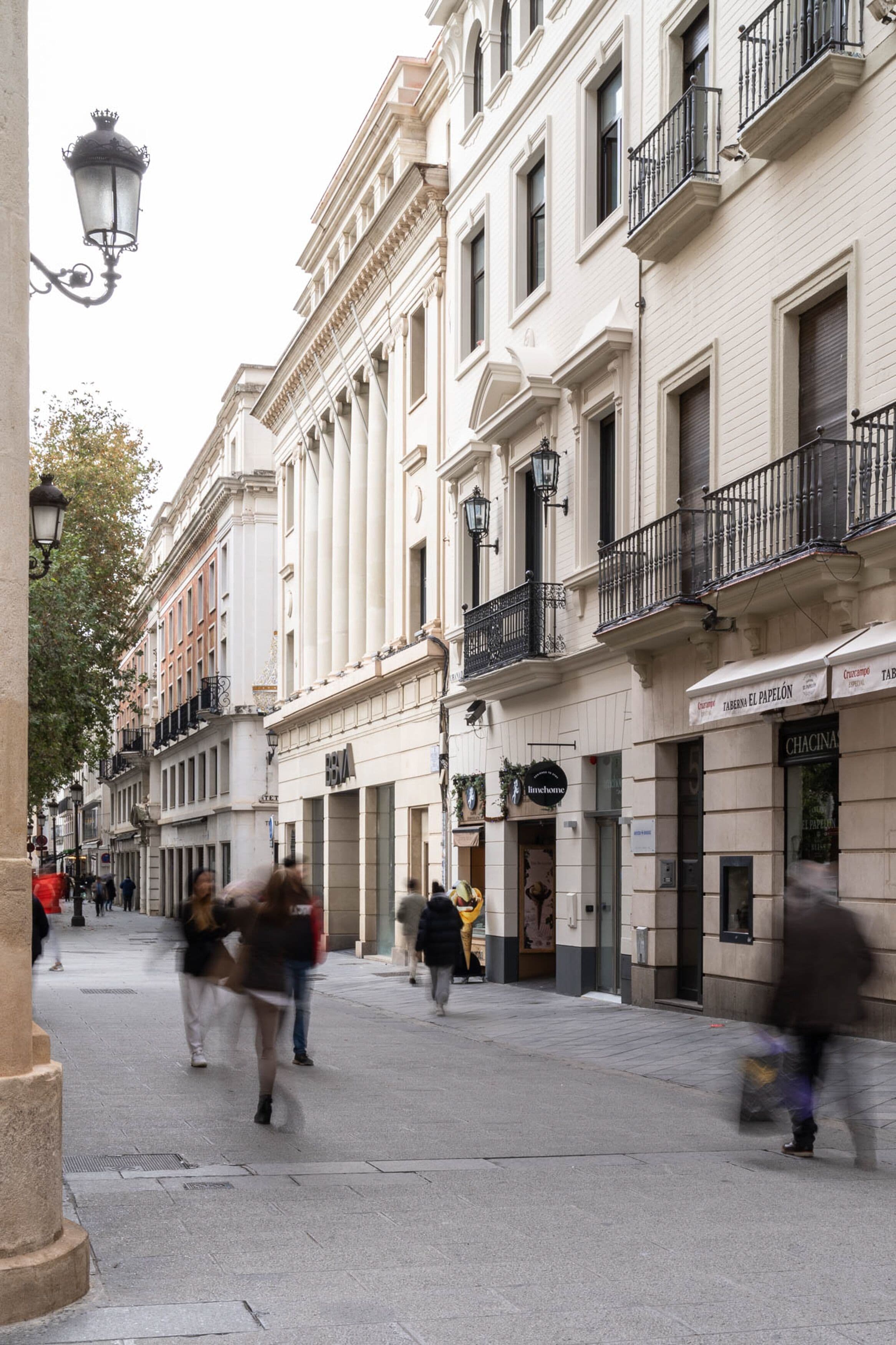 A street with historic buildings, including a restaurant named 'Chacina'.