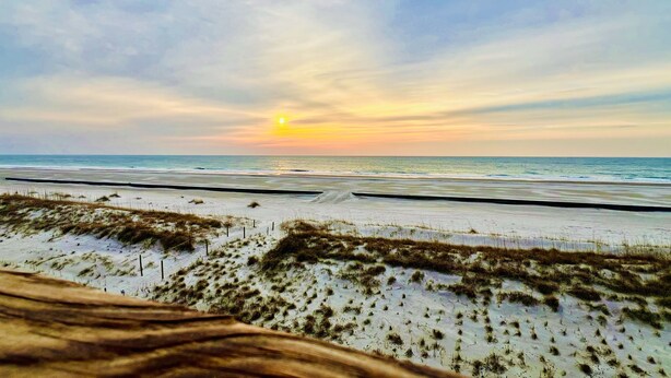 A beach with sand dunes and a sunset over the ocean. - Oceanfront Queen's Grant Condo "Tide-the-Knot" with Breathtaking Ocean Views! (Topsail Beach)
