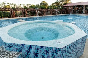 Relax by the pool with a hot tub and mosaic-tiled deck.