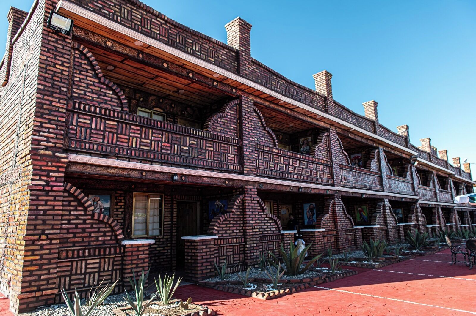 A building with a distinctive brick facade and multiple balconies.