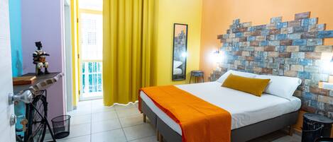 A bedroom with a bed, a bicycle, a mirror, and a wall with decorative tiles.