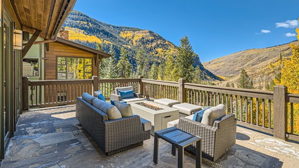 A deck with outdoor furniture, a fire pit, and a view of mountains. - Gorgeous Mountain Residence, Spectacular Views, Fire Pit (Vail)