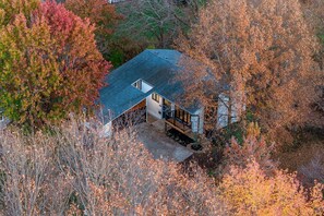 A house with a sloped roof, a small porch, and a visible window.