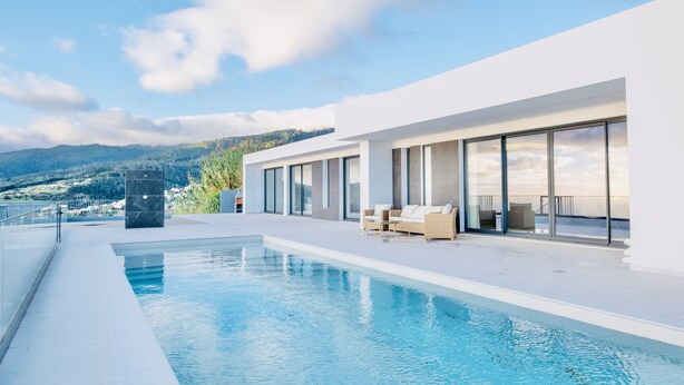 A modern pool area with a clear view of the surrounding landscape, including distant hills and a clear sky. - Vila Cales e Chadas by Your Madeira Rentals (Arco da Calheta)