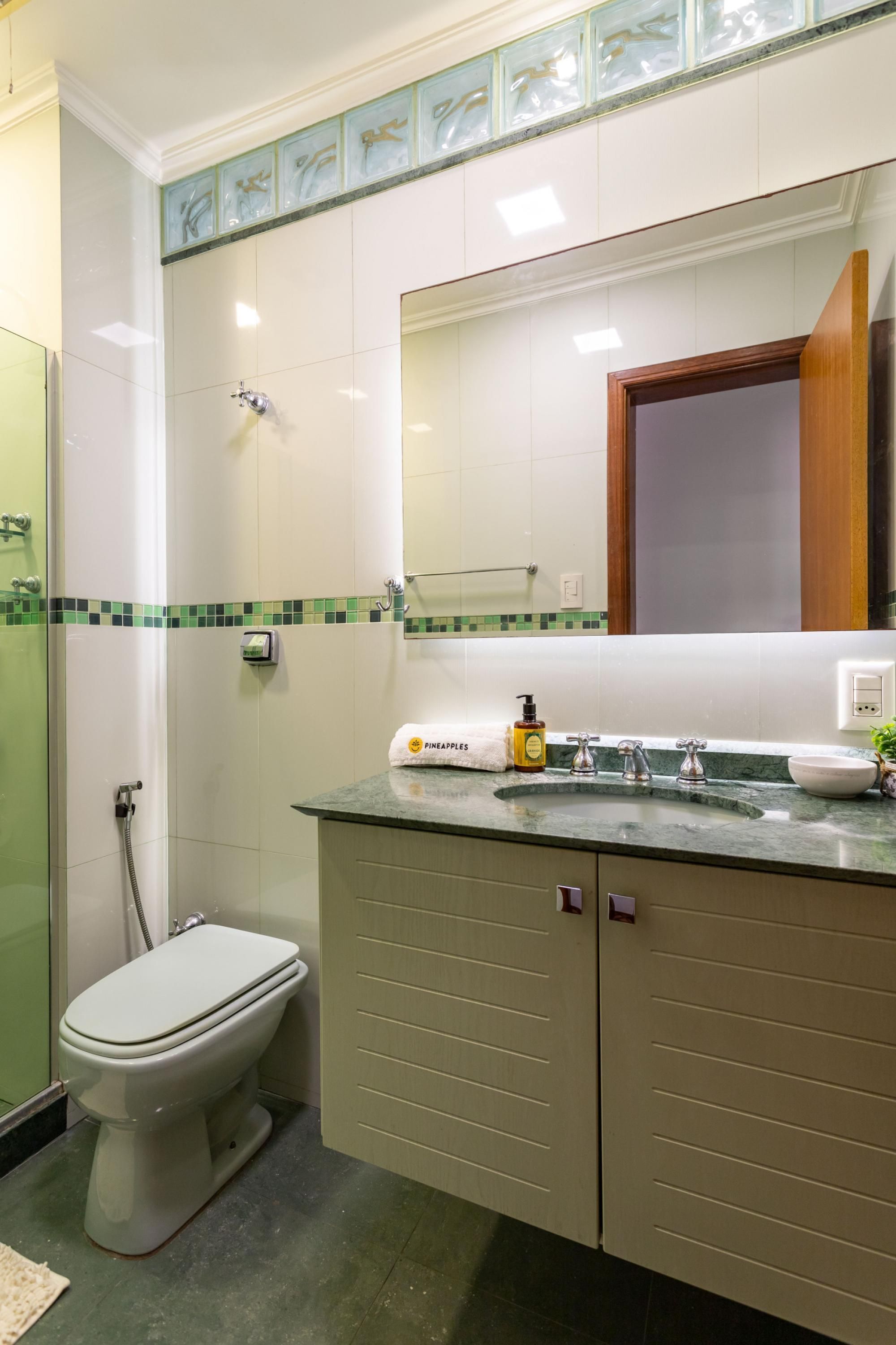 A bathroom with a toilet, sink, and shower.
