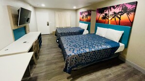 A hotel room with two beds, a desk, a TV, and a painting of palm trees. - New Star Inn. El Monte, CA - Los Angeles (El Monte)