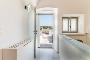 Stylish hallway leads to a balcony with a clear outdoor view.