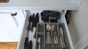 A drawer with neatly organized cutlery including knives, spoons, and forks. - Cozy Studio with Kitchenette Attached (Davenport)