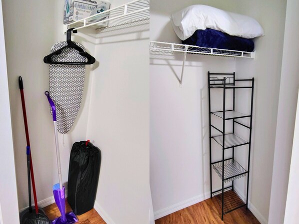 A room with a white wall, a metal shelf unit, and a hanging rack with cleaning supplies. - Cozy Studio with Kitchenette Attached (Davenport)
