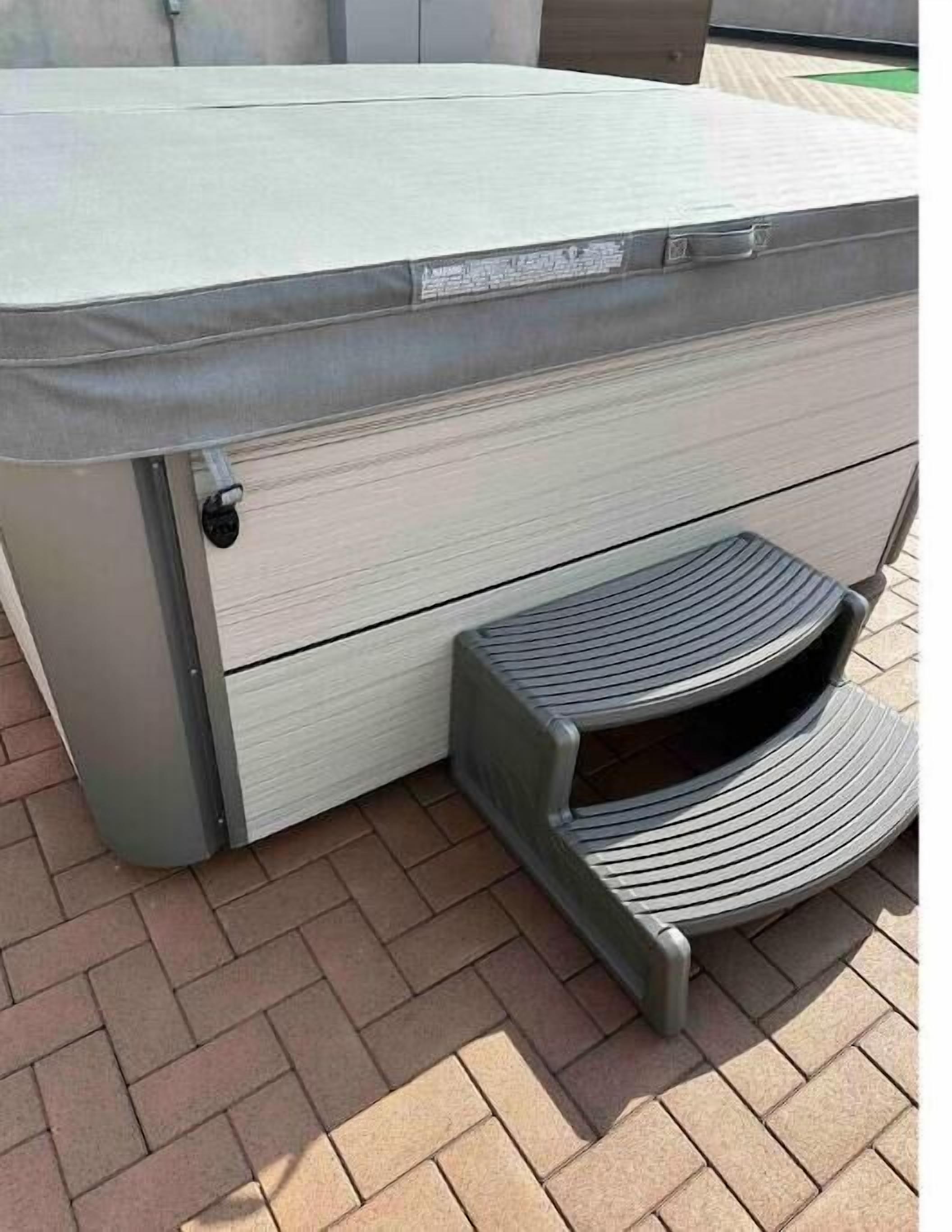 A spa or sauna with a bench and a control panel.