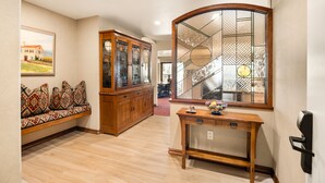 A spacious living area with a wooden bench, a glass-fronted cabinet, and a console table. - North Of Nell, Unit 4b (Aspen)
