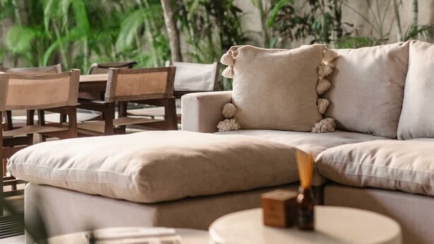 A modern living room with a beige sofa, round coffee table, and a ceiling fan. - Casa Iguana Private Villa Large Pool Beach Club (Tulum)