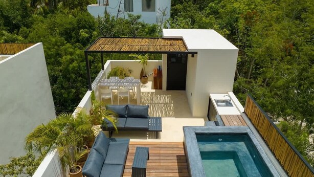 A rooftop terrace with a pool, seating area, and a pergola. - Casa Kaatal Sunny Penthouse Pool Beach Club Access (Tulum)