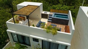 A modern rooftop with a pool, outdoor seating, and a wooden deck. - Casa Kaatal Sunny Penthouse Pool Beach Club Access (Tulum)