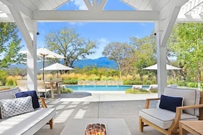 A covered outdoor seating area with a pool, lounge chairs, and umbrellas. - Sonoma Family Retreat with 4 Bdms and Pool (Sonoma)