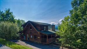 A log cabin with a porch, a chimney, and a clear sky. - Angel's Majestic View*Close to Dollywood*Game Room (SEVIERVILLE)