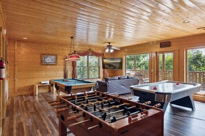 A wooden-floored room with a foosball table, pool table, and an air hockey table. - Feel Like A Millionaire Relaxing In These Views (SEVIERVILLE)