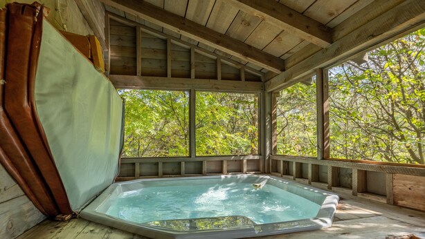 A wooden cabin with a hot tub. - Freedom Rings Where Mountains Sing (SEVIERVILLE)